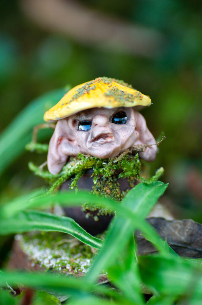 DSC_0011 OOAK handmade fantasy figurine of a Shrumlet, a tiny mushroom creature sculpted from polymer clay with moss. A whimsical forest spirit from the lore of Vhalandar, displayed in miniature glass dome.