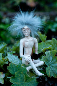 Yrisel the Frost-Leaf Nissri – handcrafted fantasy creature with ice-blue hair, pale speckled skin and woodland features – unique polymer clay art doll by Vhalandar Crafts – mythical forest miniature.