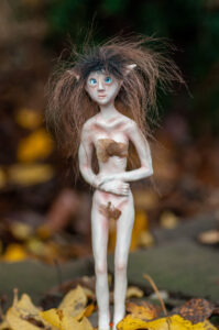 Tryll the Hollow-Sense Nissri – handmade fantasy creature figurine with wild brown hair, blue eyes and woodland detailing – artisan polymer clay sculpture by Vhalandar Crafts – magical forest creature collectible.